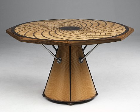 The pattern represents the seeds in a sunflower head. Made in anigr�, black walnut and stainless steel